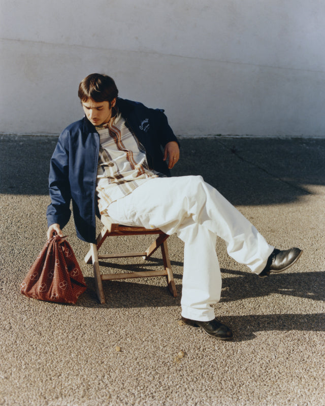 Model wearing a Racer Module Jacket in Ink / Frosted Blue and Roslin Check Shirt in Natural